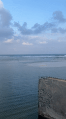 Tel Aviv waterfront: graffiti seawall, beach, and pedestrian bridge