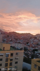 Witness captures sunset views over dense hillside city