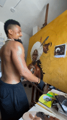 Artist paints traditional portraits using smartphone reference in Nigerian studio