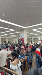 Large crowds queue in colorful barrier system in Nha Trang