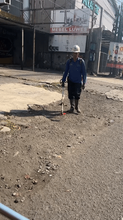 Weekday traffic and street life along a Candi main road