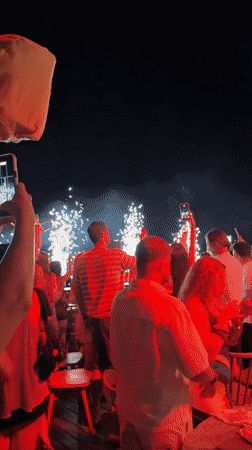 Fireworks light up a nighttime outdoor gathering in Rhodes