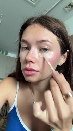 Woman applies makeup during morning routine in Ramat Gan