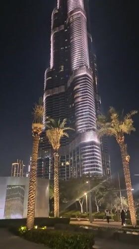 Dubai skyline illuminated at night, multiple towers observed