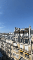 Rooftop views across Paris from a window on a clear day