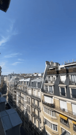 Rooftop views across Paris from a window on a clear day