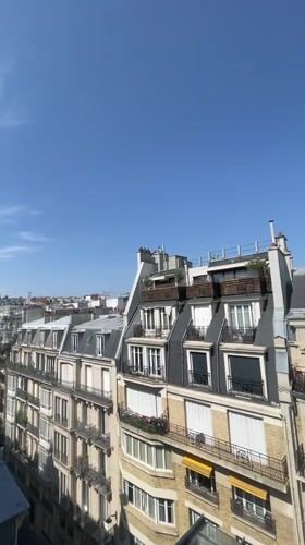Rooftop views across Paris from a window on a clear day