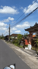 Motorcycle journey documented through rural Kerambitan, Indonesia farmlands