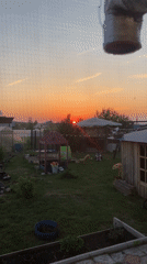 Vibrant sunset documented across residential Ольховка, Russia backyards