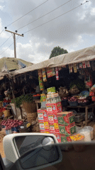 Vehicle passengers document vibrant roadside market in Abuja