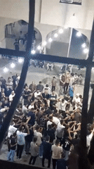 Nighttime communal celebration fills a Khan Yunis courtyard