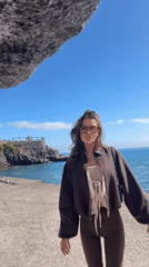 Women photograph coastal tour along Funchal waterfront