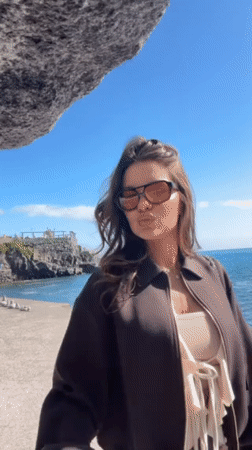 Women photograph coastal tour along Funchal waterfront