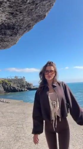 Women photograph coastal tour along Funchal waterfront