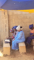 Community gathering under tent shelter in Madalla, Nigeria