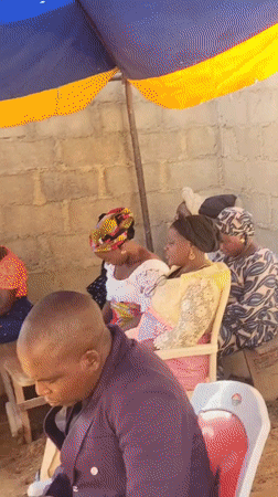 Community gathering under tent shelter in Madalla, Nigeria