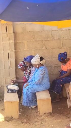 Community gathering under tent shelter in Madalla, Nigeria