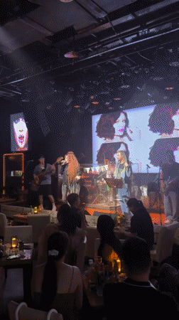 Live duo performance on dimly lit stage in Jiangbeicheng
