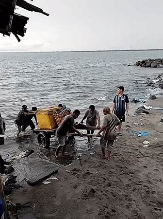Early morning waterfront activity captured in Lhokseumawe, Indonesia