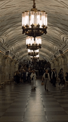 Morning commuters navigate ornate Moscow Metro stations during rush hour