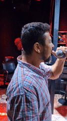 Two men enjoy karaoke session at Thailand bar