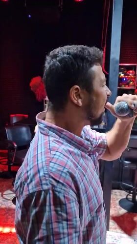 Two men enjoy karaoke session at Thailand bar