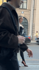 Woman in white cardigan spotted on Moscow sidewalk