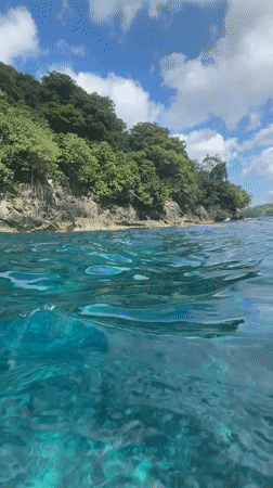 Diver enters turquoise waters off Nusa Penida coast