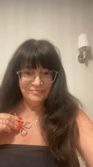 Trying on accessories and posing in a Novi Petrivtsi home