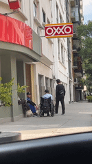 Three men gather on Mexico City sidewalk near OXXO store