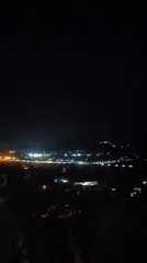 Nighttime cityscape and Buddha statue documented in Thailand