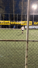 Soccer match observed through fence in Karlovo, Bulgaria