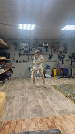 Children play indoors, person bonds with dog in rural Russia