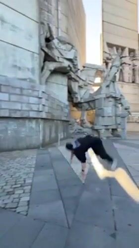 Parkour performer executes acrobatic moves at Bulgaria monument