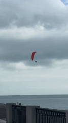 Paragliders and tourists spotted at Gagra seaside promenade