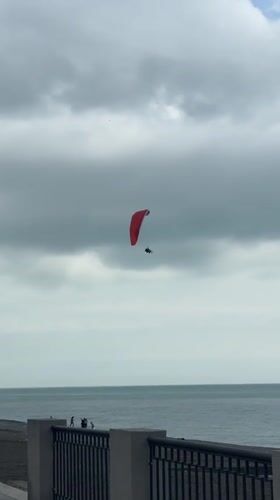 Paragliders and tourists spotted at Gagra seaside promenade