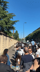 Long queue forms along Milan sidewalk Saturday morning