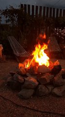 Campfire gathering at dusk in Kempelevo, Russia