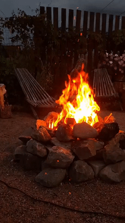 Campfire gathering at dusk in Kempelevo, Russia
