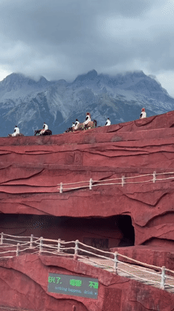 Traditional cultural performance on red terraced stage, Yulong County