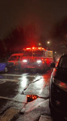 Fire engine parks on wet cracked street in New York