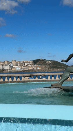 Sun, sand, and a surfer statue on A Coruña's waterfront
