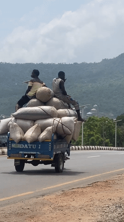 Men ride atop loaded truck in Adankolo Nigeria