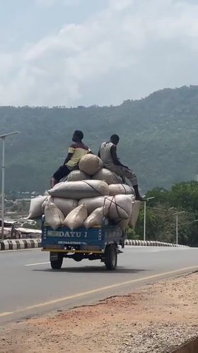 Men ride atop loaded truck in Adankolo Nigeria