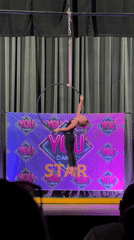 Aerial hoop performer demonstrates acrobatics at indoor venue