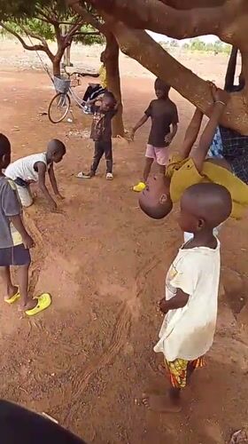 Children play under trees in Dungu, Ghana