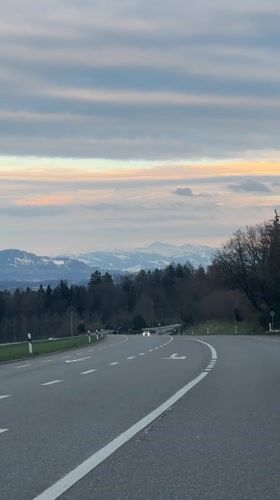 Car travels winding road in Maur, Switzerland