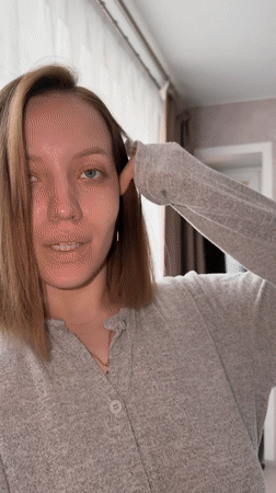 Woman documents morning beauty routine in Russian bedroom selfies