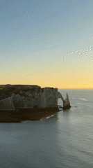Golden hour at Étretat's chalk cliffs and sea arches