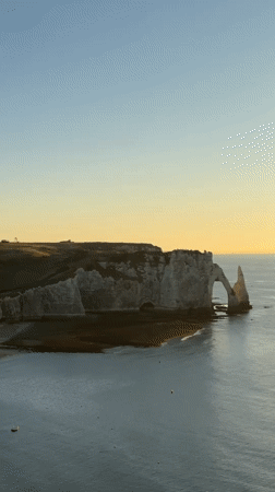 Golden hour at Étretat's chalk cliffs and sea arches